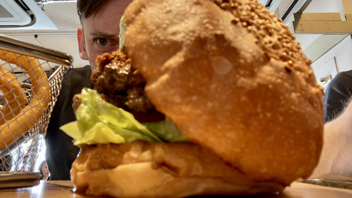 Andy Fossett is just about to eat a spicy chili burger in Kiryu Japan